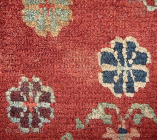 an antique tibetan khaden in superb condition. multicolored lotus flower on a fantastic red background color, beautiful red green border, superb wool and unusual medaillion drawing. the slightly white spot visible on  ...