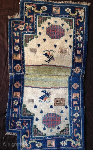 late 19th century tibetan white ground saddle rug with very nice all natural colors,. very good condition,super fine wool and very tight knotting. abrashed light green center and deeper green corners..  