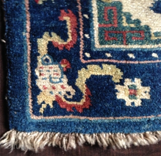 late 19th century tibetan white ground saddle rug with very nice all natural colors,. very good condition,super fine wool and very tight knotting. abrashed light green center and deeper green corners..  