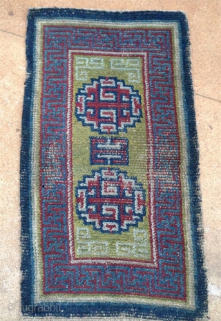 early tibetan saddle rug with beautiful clear old colors. exquisite light green back ground. very fine weave and super soft handle.. mid 19th century         