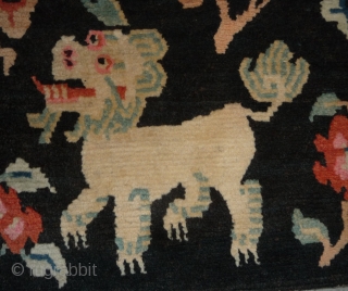 old tibetan khaden showing together the most popular motifs since the late 19th c. as dragon, tiger, lion and rarer seen on rugs garuda. 
according to a probably first third 20th c  ...