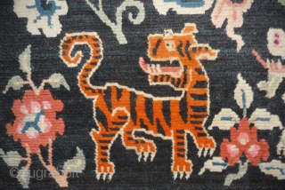 old tibetan khaden showing together the most popular motifs since the late 19th c. as dragon, tiger, lion and rarer seen on rugs garuda. 
according to a probably first third 20th c  ...