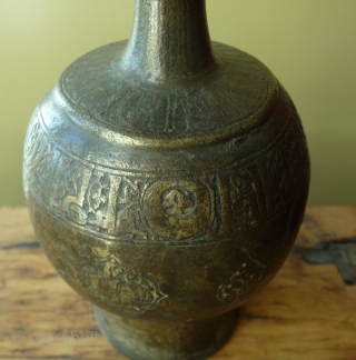 early islamic period bronze rose-water bottle, eastern iran, 10-12th century. richly decorated and with script. the bottom is missing. it has been purchased in afghanistan in the early 20th century. for similar  ...