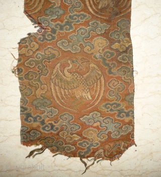 tiny fragment great charisma! silk brocade fragment from the late ming era with crane roundel. strong  imagery refering to long life and immortality according to the daoistic tradition, one row of  ...