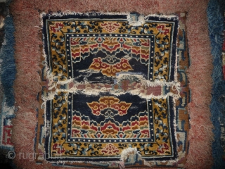 fragment of a rare tibetan saddle rug. it is late 19th century but all colors are natural. the main color is a wonderfull gold yellow. uncommon is its small size, trapezoidal shape  ...