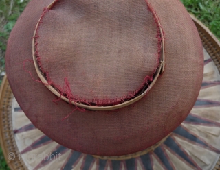 this is a beautiful and rare antique indonesian hat from the south sulawesi. it is made of palm leaves, decorated with pieced cloth and embroidery.the round base is perhaps bambu. please note  ...