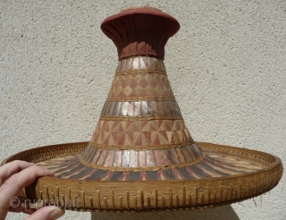 this is a beautiful and rare antique indonesian hat from the south sulawesi. it is made of palm leaves, decorated with pieced cloth and embroidery.the round base is perhaps bambu. please note  ...