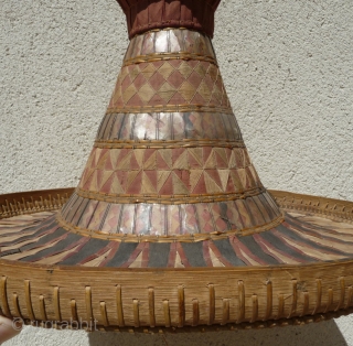 this is a beautiful and rare antique indonesian hat from the south sulawesi. it is made of palm leaves, decorated with pieced cloth and embroidery.the round base is perhaps bambu. please note  ...