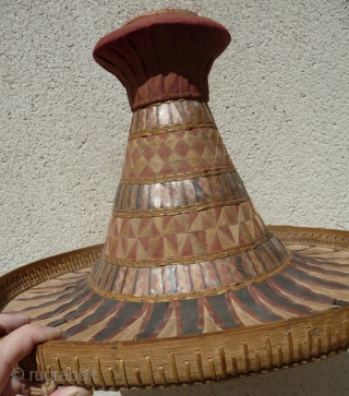 this is a beautiful and rare antique indonesian hat from the south sulawesi. it is made of palm leaves, decorated with pieced cloth and embroidery.the round base is perhaps bambu. please note  ...