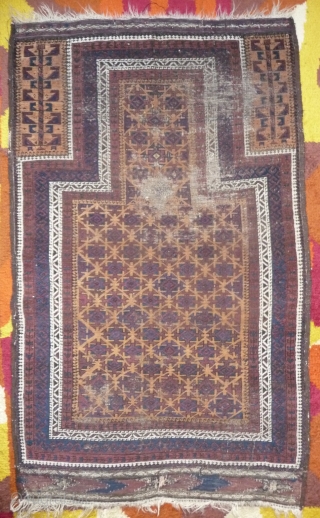 beautiful baluch prayer rug with prayer wear.attrativ hand panel and turkmen field design with a strong reciprocity effect.lots of interesting small amulets. all natural colors with very nice apricot ground color.silk highlights  ...