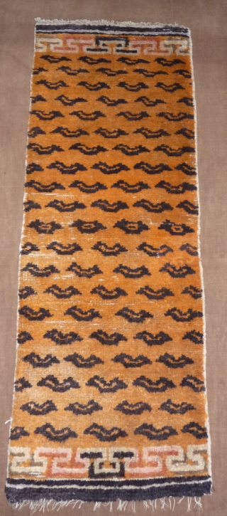 not a tibetan weaving but this small tiger rug was intented for a tibetan monastery to be hung in a door way or as pillar decoration. despite of its late 19thc or  ...