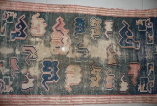 all about clouds. an early 20th century tibetan popart rug with an abrashed green sky background. damage but a funny unique piece; note the integration of a cloud design in the traditional  ...