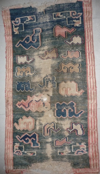 all about clouds. an early 20th century tibetan popart rug with an abrashed green sky background. damage but a funny unique piece; note the integration of a cloud design in the traditional  ...