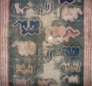 all about clouds. an early 20th century tibetan popart rug with an abrashed green sky background. damage but a funny unique piece; note the integration of a cloud design in the traditional  ...