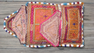 Afghan Embroidered Purse:  
Several intricate embroidery techniques. 
Metallic threads in the couching embroidery. 
Multi-color seed beads surround. 
Circa 1920s. 
Attributed to the Hazara ethnic group. 
Size: 7 inches fully open by  ...