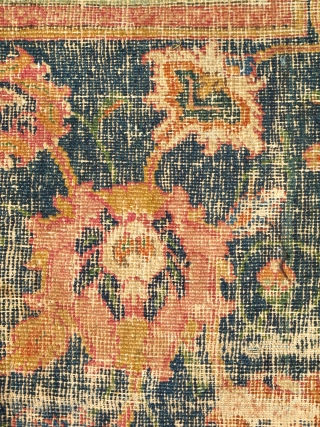 Border Fragment of a 17th century Isfahan or Indo-Isfahan Carpet. This fragment preserves a small portion of the red lac ground with a blue cloudband and floral ornament. A larger portion of  ...