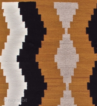 This simple small vintage mid 20th century Navajo rug paints waves of natural ivory and brown to form subtle intimations of side-borders. A column of grey diamonds is drawn along the center  ...