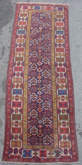 Northwest Persian Kurdish long rug with a very graphic geometric border and floral field. Size = 3'6" x 10'3". Inv. # 14834.           