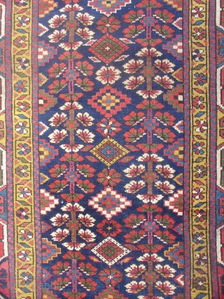 Northwest Persian Kurdish long rug with a very graphic geometric border and floral field. Size = 3'6" x 10'3". Inv. # 14834.           