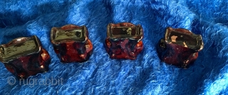 A very rare 19thC set of four glazed Redware Window Stops or Furniture Lifts in the form of Classical Stylized Claw Feet or Lions Paws covered in mottled lead & manganese glaze  ...