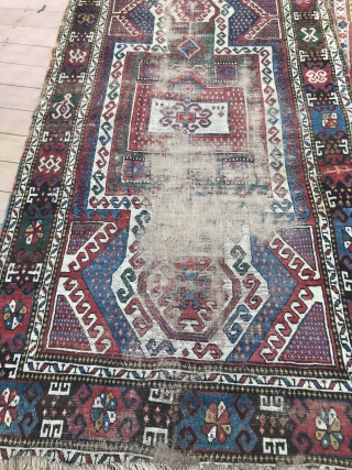 Sevan Kazak Caucasian rug 54” x 94”  with Armenian writing worn throughout field borders in good shape. A lone human figure upper left corner        