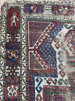 Sevan Kazak Caucasian rug 54” x 94”  with Armenian writing worn throughout field borders in good shape. A lone human figure upper left corner        