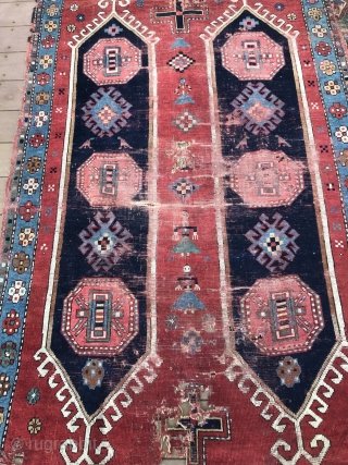 Caucasian village rug fragment dated Hijri 132_  (as early as 1902) three female figures in center. A graphic piece, worn and challenged condition with holes and losses. 48” x 73”  