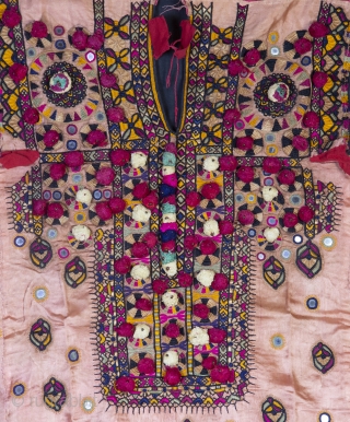 • DRESS FRONT •

Sindh, Pakistan, mid 20th- century
The work of Sindhi embroidery motifs is designed peculiarly in silk and cotton thread on either silk or cotton.

The tassels and the mirrors are creating  ...