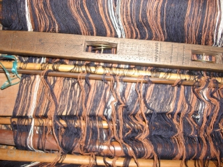 Mei-Fu Li minority, Hainan Island, South China.  Back-strap weaving loom with carved wood and bamboo components that show ancient totems and symbols.---Back-strap from woven rattan.---Cotton warp and partial weft intact.---Oldest carved  ...