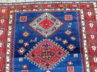An elegant blue field Kazak rug with a particularly appealing border design.  Circa 1850, 5'1" x 8'4" 
              