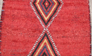 One of 6 dramatic and colorful sleeping rugs purchased from Baluchi tribesmen living in the area between Quetta and Kandahar. The rug measures 47" x 69".  The wool is long and  ...