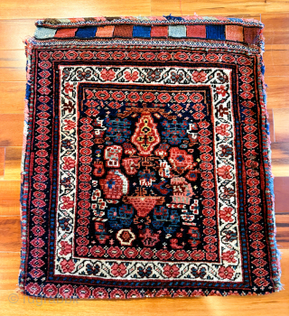 Late 19th C. Kurd bag, 25" x 26", featuring a beautifully drawn multicolored flat woven back, and a sumptuous naively drawn pile face. Possibly a dowry piece as it doesn't appear ...
