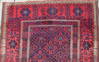 An attractive example of Baluch weaving from the Khorasan region circa 1900, 3' x 5'8", featuring a flower and vine border surrounding a central diamond lattice field. Spacious open treatment of top  ...