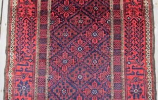 An attractive example of Baluch weaving from the Khorasan region circa 1900, 3' x 5'8", featuring a flower and vine border surrounding a central diamond lattice field. Spacious open treatment of top  ...