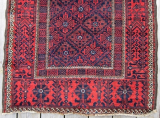 An attractive example of Baluch weaving from the Khorasan region circa 1900, 3' x 5'8", featuring a flower and vine border surrounding a central diamond lattice field. Spacious open treatment of top  ...