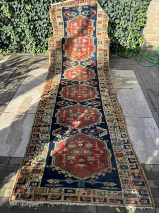 Vintage Azerbaijani Runner Rug – 360 × 103 cm

Beautiful vintage runner rug from Azerbaijan, featuring a striking traditional geometric design. The rug has a deep navy blue field with a sequence of  ...