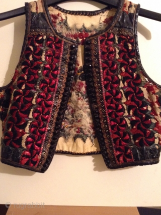 I believe this is an Hungarian or Transylvanian vest, but I am not positive.  It is embroidered on leather and  still has some of the fur lining.
There are slight damages  ...