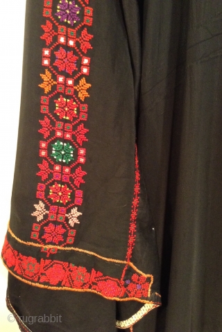 This is a Palestinian dress stemming from the 1930s.  It has been embroidered on the original black fabric and remains in very good condition.  It has been carefully handled in  ...