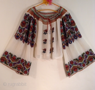 This is a very beautiful and rare Roumanian blouse made between the two Worild Wars in one specific village in Roumania.
The embroidery is extremely tiny and dense with black yarn used to  ...