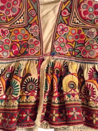 This is a child's dress from Gujarat, India.  It is a wrap around dress that looks to be about a size 3 to 5.  It is in very good condition  ...