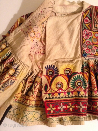 This is a child's dress from Gujarat, India.  It is a wrap around dress that looks to be about a size 3 to 5.  It is in very good condition  ...