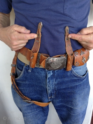 Afghanistan horseman's leather belt.  Very unusual. Beautifully decorated with silver pieces.  There are 4 pouches, 2 for money and 2 for knives or other utensils.  The buckle Is silver  ...