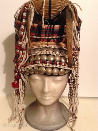 Akha Hilltribe Woman's Hat, either from Thailand or Burma. Woven Bamboo, rattan, seeds, metal beads, glass beads, shells, cotton.  18 inches long and 8 inches wide. Perfect condition.




.    