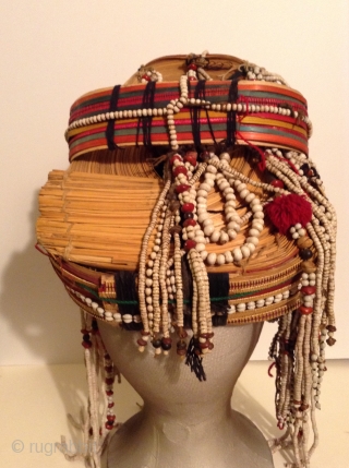 Akha Hilltribe Woman's Hat, either from Thailand or Burma. Woven Bamboo, rattan, seeds, metal beads, glass beads, shells, cotton.  18 inches long and 8 inches wide. Perfect condition.




.    