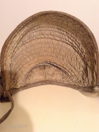 This is a rare Pilgram's Bonnet from the early 19th century.  It has metal stays between the inner and outer fabric that allow the wearer to flatten the bonnet for storage  ...