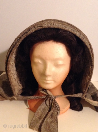 This is a rare Pilgram's Bonnet from the early 19th century.  It has metal stays between the inner and outer fabric that allow the wearer to flatten the bonnet for storage  ...