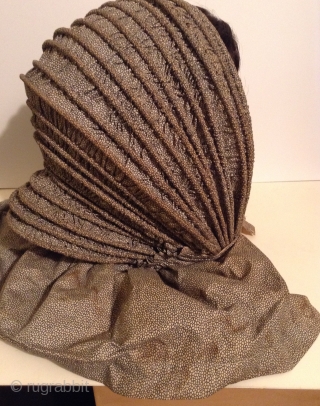 This is a rare Pilgram's Bonnet from the early 19th century.  It has metal stays between the inner and outer fabric that allow the wearer to flatten the bonnet for storage  ...