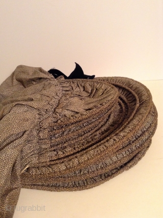 This is a rare Pilgram's Bonnet from the early 19th century.  It has metal stays between the inner and outer fabric that allow the wearer to flatten the bonnet for storage  ...