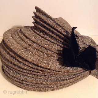 This is a rare Pilgram's Bonnet from the early 19th century.  It has metal stays between the inner and outer fabric that allow the wearer to flatten the bonnet for storage  ...