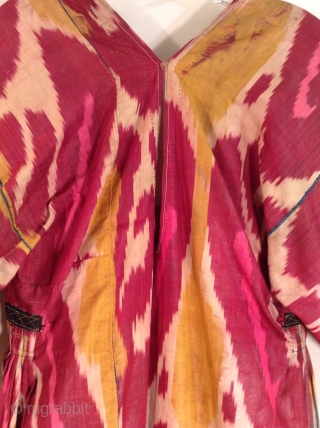 This is an Uzbek ikat silk dress with very traditional colors.  It is in very good condition and would fit a large woman.         